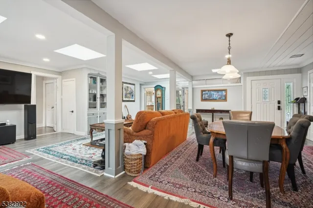a living room with furniture a rug and a flat screen tv