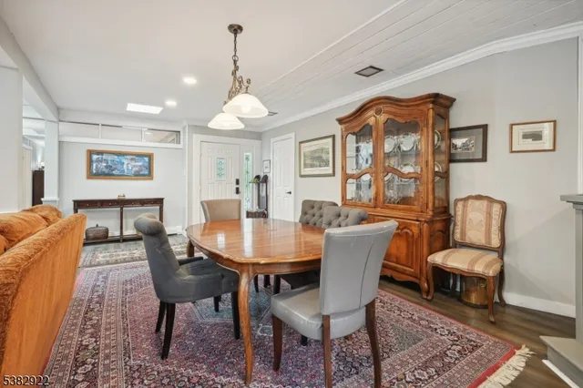 a view of a a dining room with furniture window and wooden floor