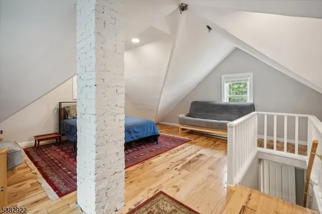a living room with furniture rug and wooden floor