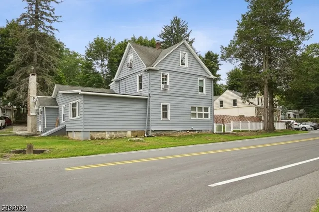 a front view of house with yard and trees
