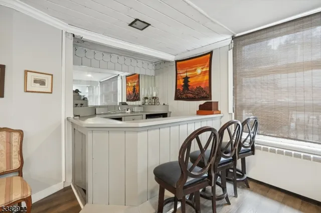 a kitchen with a table chairs sink and window