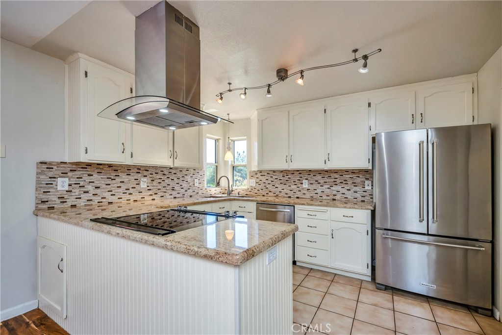15632 Little Peak Road Hidden Valley Lake, CA 95467 - Photo 12 of 42 a kitchen with stainless steel appliances granite countertop a sink stove and refrigerator