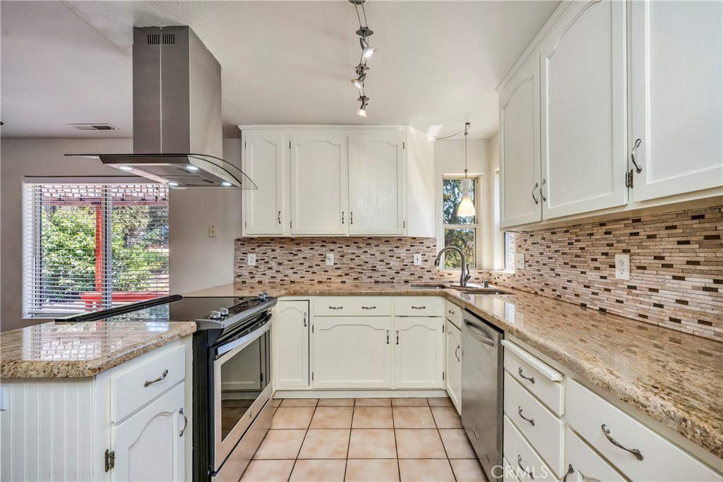 15632 Little Peak Road Hidden Valley Lake, CA 95467 - Photo 14 of 42 a kitchen with granite countertop a sink stove and cabinets