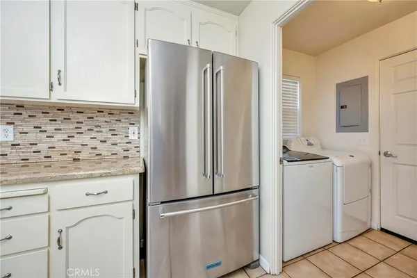 a kitchen with granite countertop cabinets and refrigerator