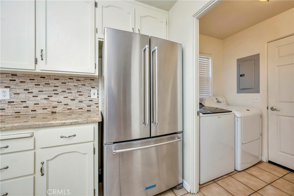 15632 Little Peak Road Hidden Valley Lake, CA 95467 - Photo 16 of 42 a kitchen with granite countertop cabinets and refrigerator