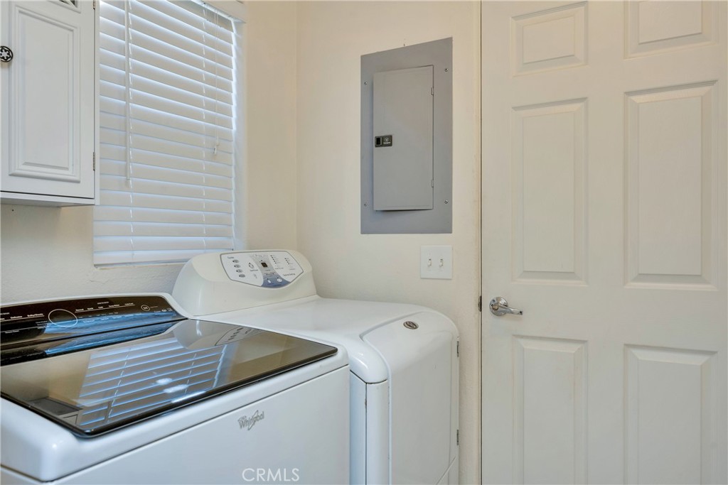 15632 Little Peak Road Hidden Valley Lake, CA 95467 - Photo 17 of 42 a bathroom with a granite countertop sink and a washing machine