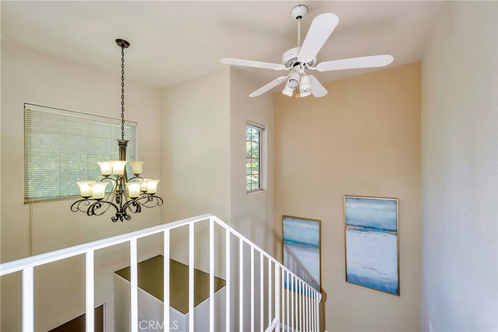 15632 Little Peak Road Hidden Valley Lake, CA 95467 - Photo 20 of 42 a view of a dining room with a chandelier fan and wooden floor