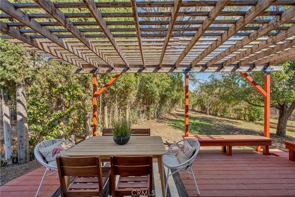 15632 Little Peak Road Hidden Valley Lake, CA 95467 - Photo 33 of 42 a view of a patio with table and chairs and wooden floor