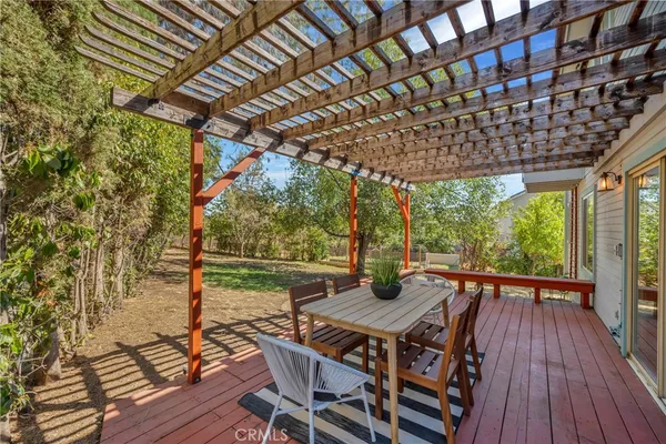 a view of a house with backyard porch and sitting area