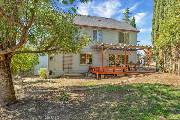 a backyard of a house with barbeque oven table and chairs