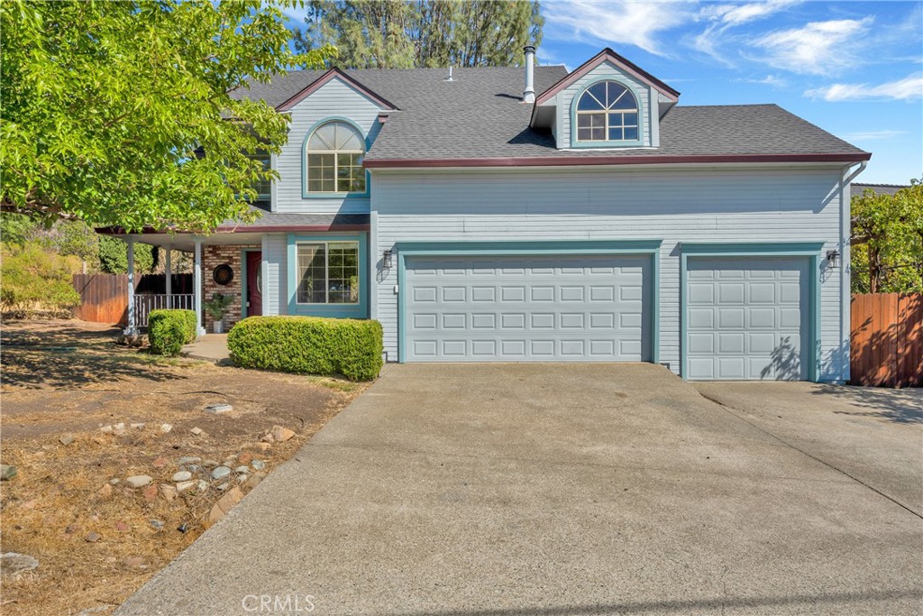15632 Little Peak Road Hidden Valley Lake, CA 95467 - Photo 39 of 42 a front view of a house with a yard and garage
