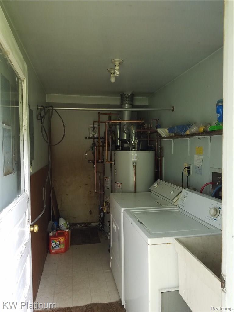 2847 Michigan Road Port Huron, MI 48060 - Photo 17 of 18 LAUNDRY ROOM. NOTICE THE 2 LIGHT BULBS, THE TENANTS TURN ON THEIR OWN POWER TO THE ROOM TO OPERATE THE WASHER AND DRYER ON THEIR METER.