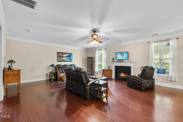 a living room with furniture a fireplace and a flat screen tv