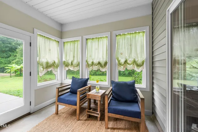 a view of a room with furniture and a window