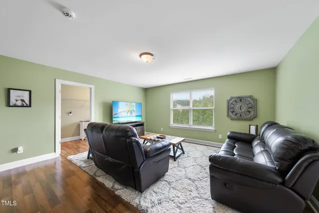 a living room with furniture window and wooden floor