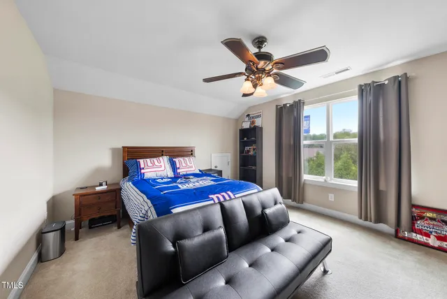 a bedroom with a bed and a large window