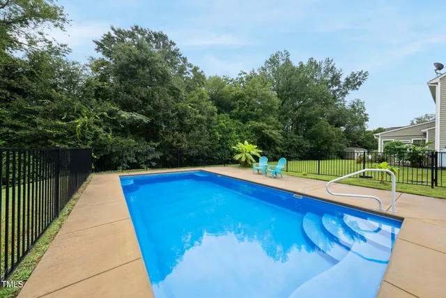 a view of a swimming pool with a yard