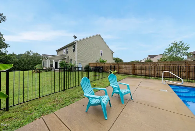 a view of backyard with seating area and green space