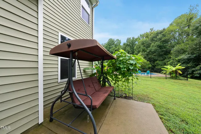 a view of backyard of house with seating space
