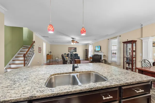 a kitchen with a sink and a mirror