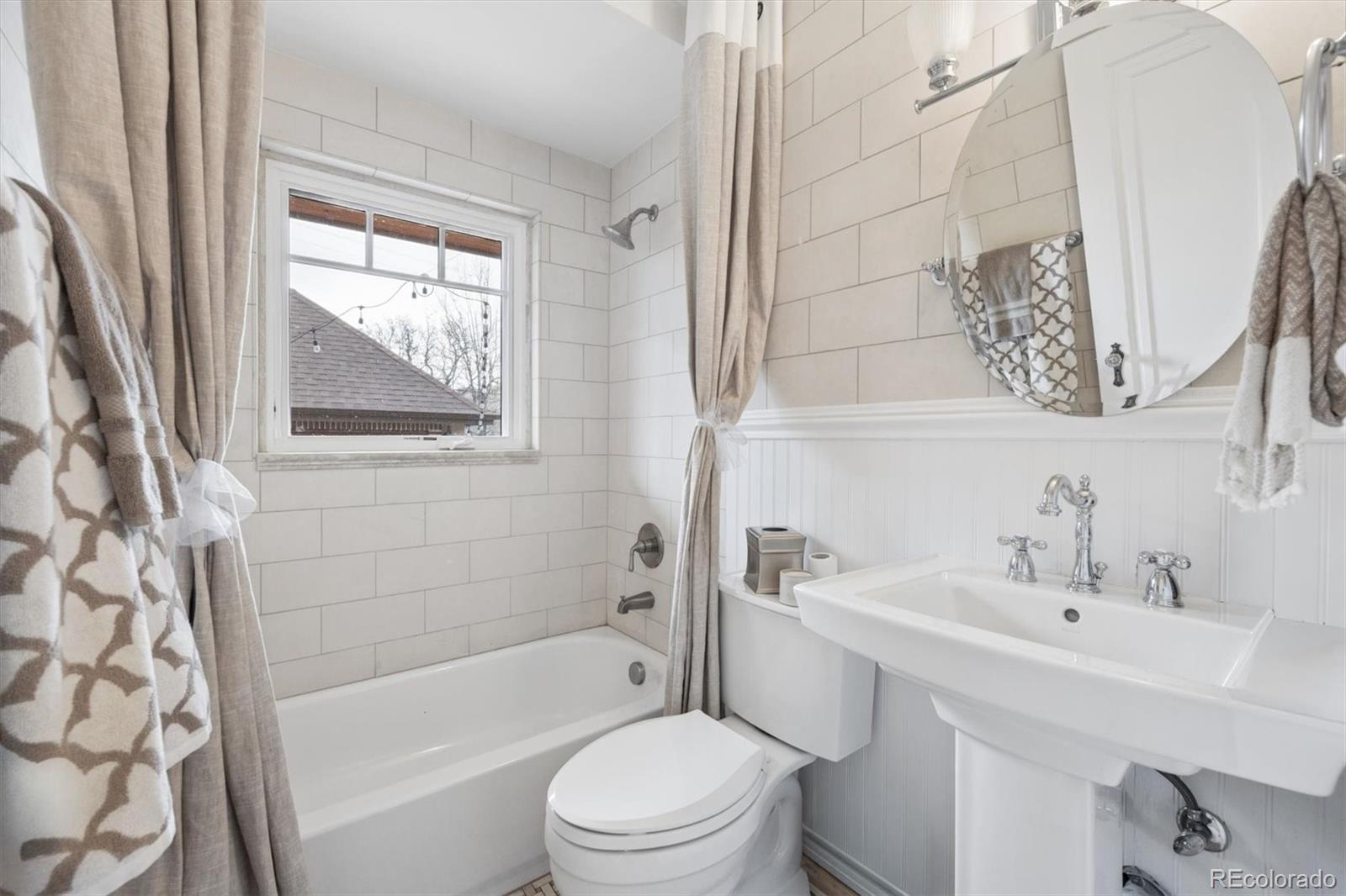 2700 Stuart Street Denver, CO 80212 - Photo 12 of 49 a bathroom with a sink toilet and shower