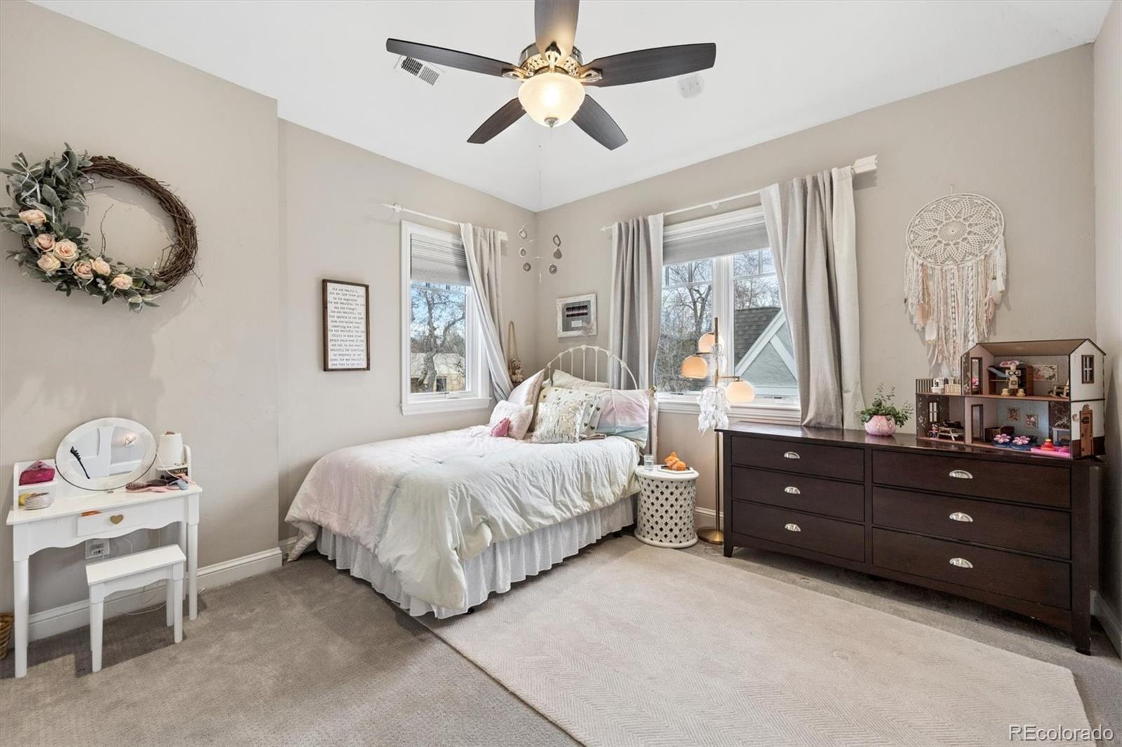 2700 Stuart Street Denver, CO 80212 - Photo 21 of 49 a bedroom with a bed and a chandelier