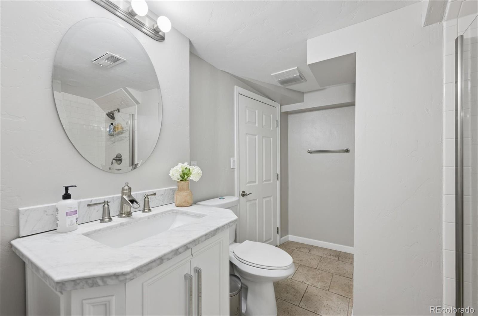 2700 Stuart Street Denver, CO 80212 - Photo 29 of 49 a bathroom with a sink and a mirror