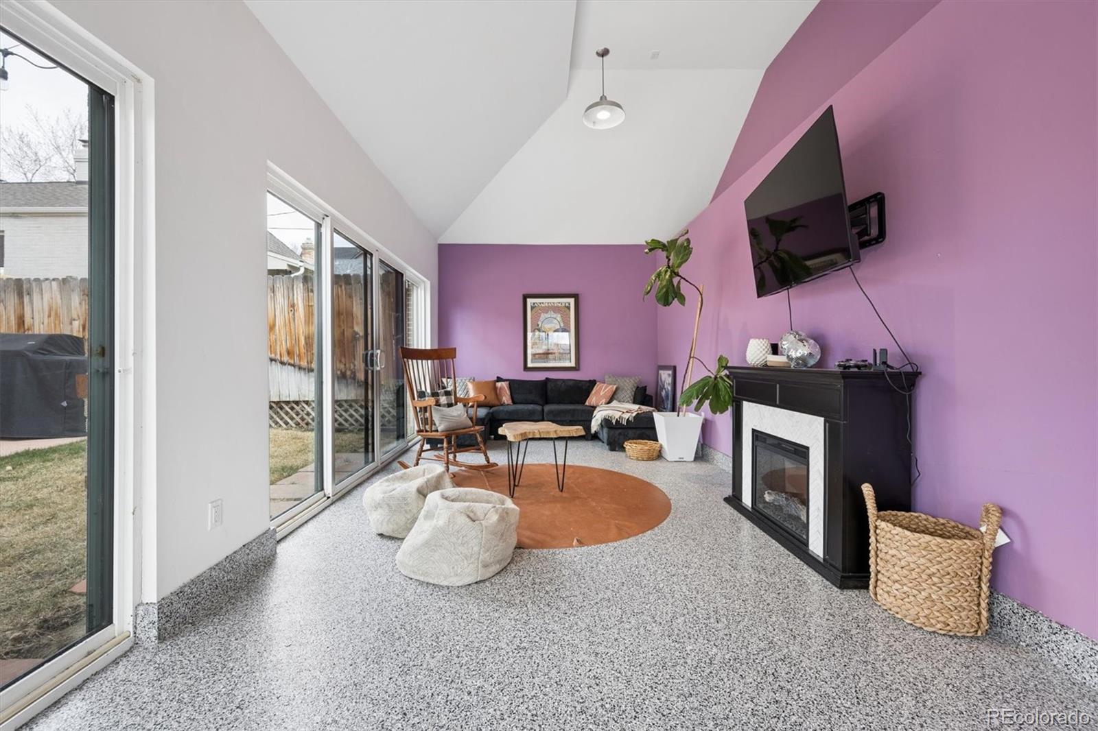 2700 Stuart Street Denver, CO 80212 - Photo 30 of 49 a living room with furniture a flat screen tv and a fireplace