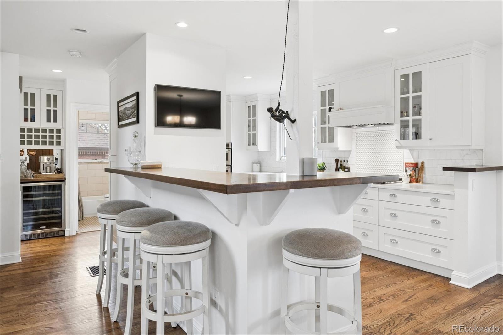 2700 Stuart Street Denver, CO 80212 - Photo 6 of 49 a kitchen with stainless steel appliances kitchen island granite countertop a table and chairs in it