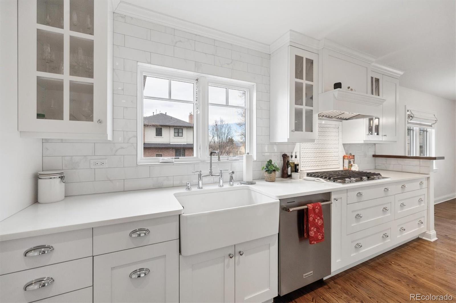 2700 Stuart Street Denver, CO 80212 - Photo 9 of 49 a kitchen with cabinets wooden floor and a sink
