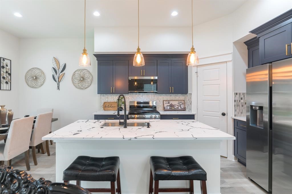 890 Lucky Street, Unit A Houston, TX 77088 - Photo 12 of 48 a kitchen with a sink cabinets and stainless steel appliances