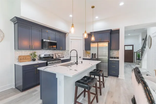 a kitchen that has a sink and a stove