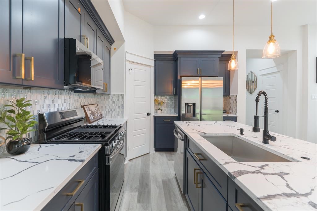 890 Lucky Street, Unit A Houston, TX 77088 - Photo 14 of 48 a kitchen that has a sink and a stove