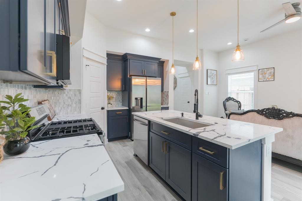 890 Lucky Street, Unit A Houston, TX 77088 - Photo 15 of 48 a kitchen with a sink and stove