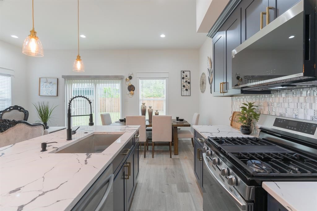 890 Lucky Street, Unit A Houston, TX 77088 - Photo 16 of 48 a kitchen with a stove and a sink