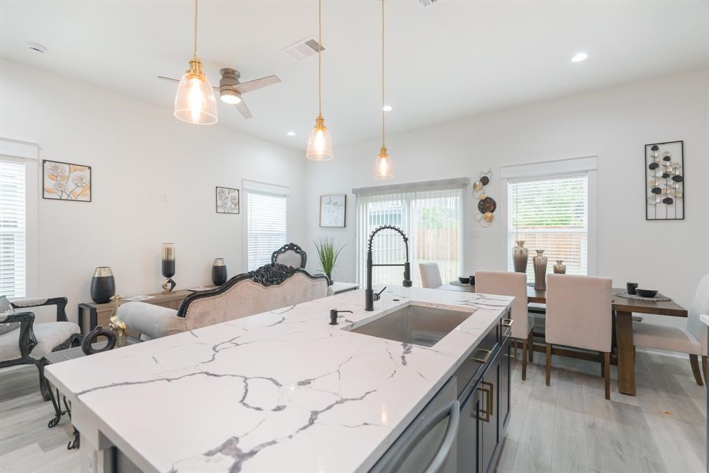 890 Lucky Street, Unit A Houston, TX 77088 - Photo 17 of 48 a large kitchen with kitchen island a dining table and chairs