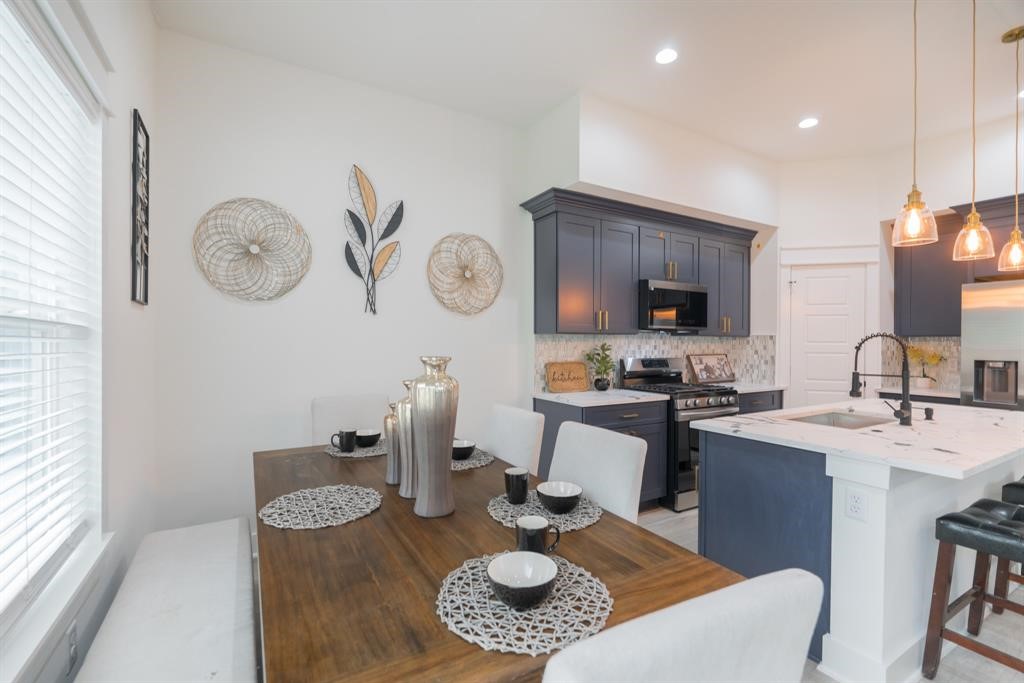 890 Lucky Street, Unit A Houston, TX 77088 - Photo 19 of 48 a kitchen with a table chairs and a stove