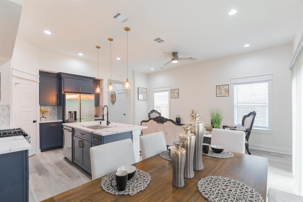 890 Lucky Street, Unit A Houston, TX 77088 - Photo 20 of 48 a large kitchen with a table and chairs