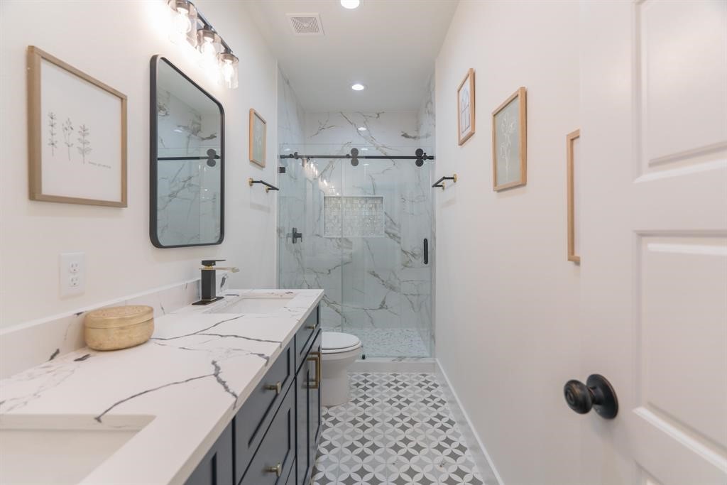 890 Lucky Street, Unit A Houston, TX 77088 - Photo 30 of 48 a bathroom with a sink toilet and shower