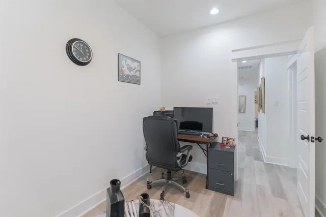 a bedroom with a bed and a painting on the wall