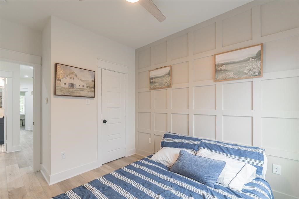 890 Lucky Street, Unit A Houston, TX 77088 - Photo 37 of 48 a bedroom with a bed and a painting on the wall