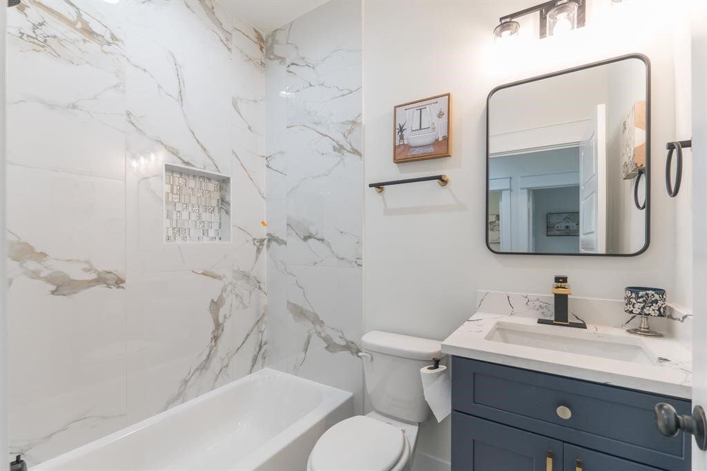 890 Lucky Street, Unit A Houston, TX 77088 - Photo 38 of 48 a bathroom with a sink vanity mirror and toilet