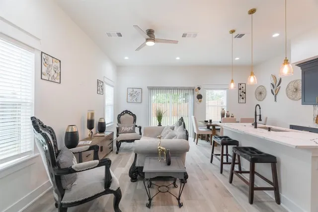 a living room with furniture and kitchen view
