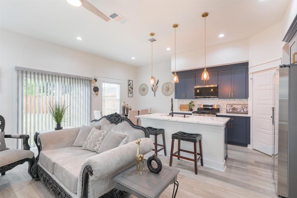 890 Lucky Street, Unit A Houston, TX 77088 - Photo 7 of 48 a living room with furniture and kitchen view