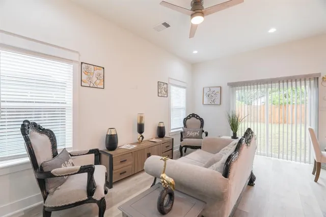 a kitchen with a stove a sink a dining table and chairs