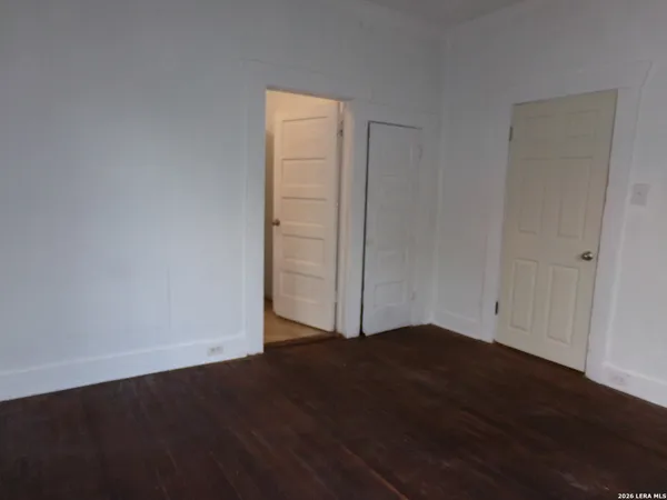 a white toilet sitting next to a bath tub