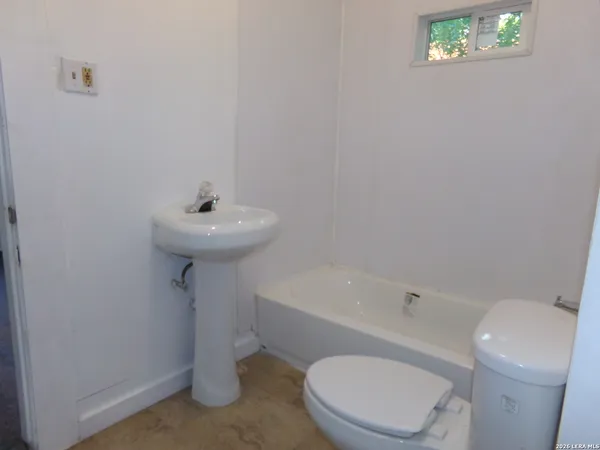 a bathroom with a sink toilet and bathtub