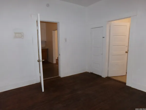 an empty room with wooden floor