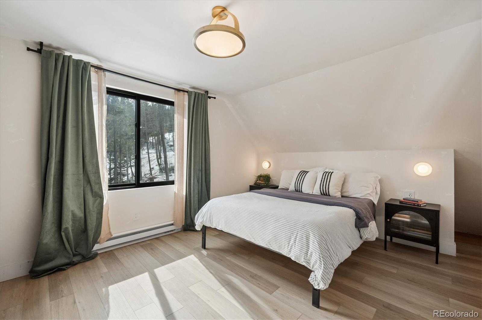1633 Sinton Road Evergreen, CO 80439 - Photo 41 of 50 a bedroom with a bed and window