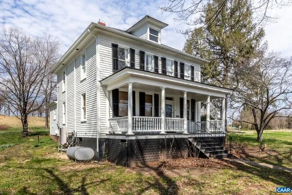 a front view of house with a garden